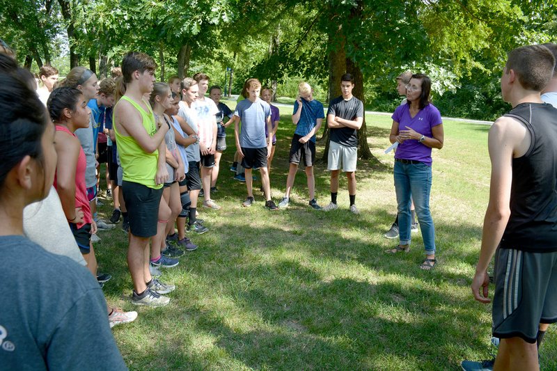 Graham Thomas/Siloam Sunday Siloam Springs cross country runners listen as head coach Sharon Jones gives instructions during practice on Monday, Aug. 6, at the Simmons Course.