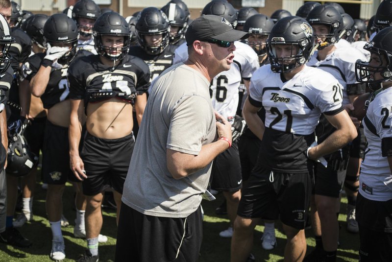 Bentonville head football coach Jody Grant talks to his players during a practice Aug. 9 at Bentonville High School. 