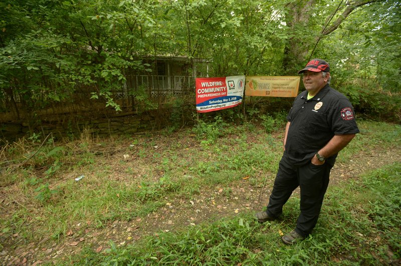 NWA Democrat-Gazette/ANDY SHUPE Dennis Greenoe, fire prevention officer for the Evansville Fire Department, leads a tour Wednesday, Aug. 8, 2018, of a house and detached garage that has been donated by the state to his department for use as a fire prevention office and temporary shelter for residents affected by fire.