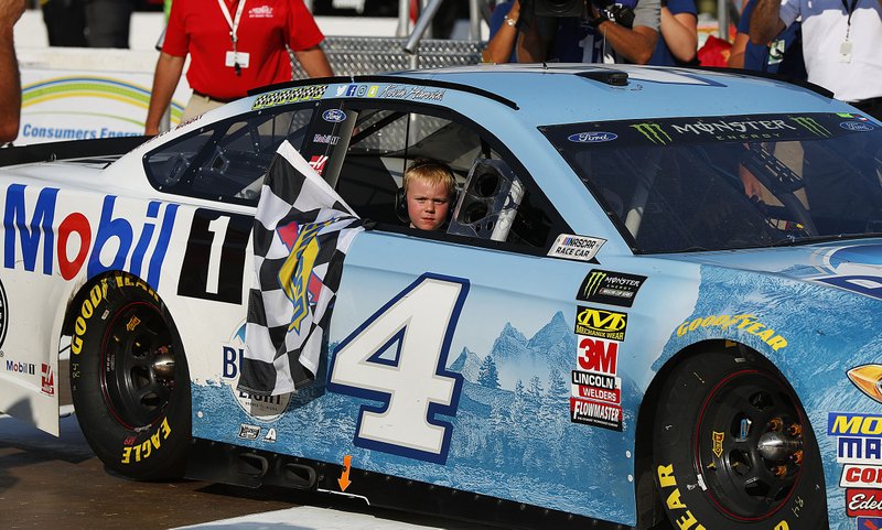 Kevin Harvick’s son, Keelan, rides into the Winner’s Circle with his father after Sunday’s race in Brooklyn, Mich.