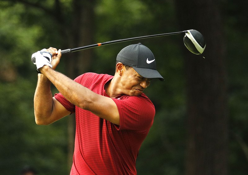 Tiger Woods reacts to his drive on the 17th hole during the final round of the PGA Championship on Sunday at Bellerive Country Club in St. Louis. Woods pushed his tee shot right of the creek running along the right side of the hole.