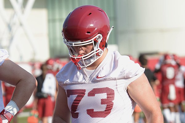 Arkansas offensive lineman Noah Gatlin (73) participates in a drill Friday, Aug. 3, 2018, during practice at the university practice field on campus in Fayetteville.