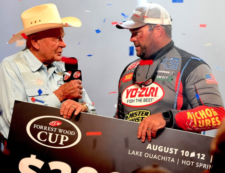 Forrest Wood (left) of Flippin, the founder of Ranger Boats, presents the $300,000 Forrest Wood Cup first-place check to Clent Davis of Montevallo, Ala., on Sunday in Hot Springs - Photo by Bryan Hendricks
