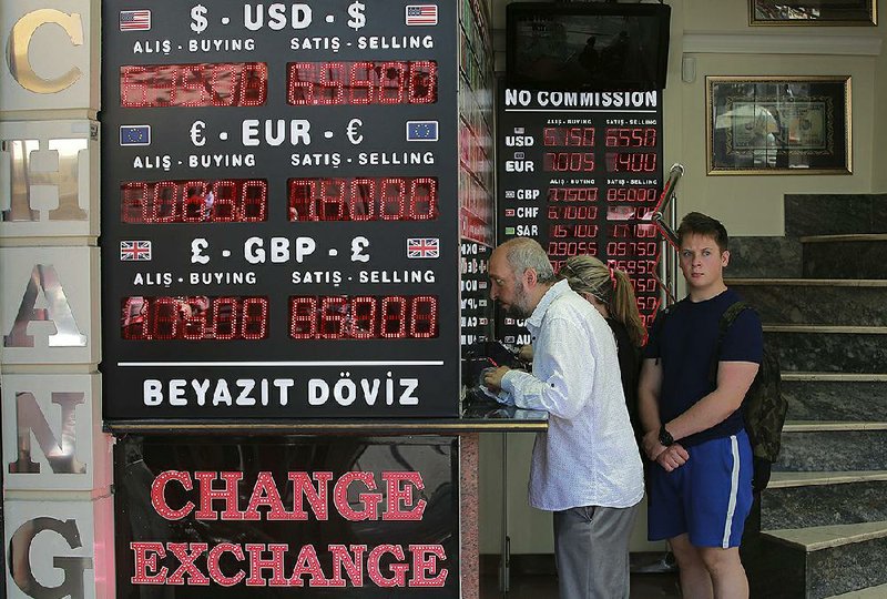 People line up Monday at a foreign currency exchange shop in Istanbul. Turkey’s central bank announced a series of measures Monday to free up cash for banks as the country grapples with a currency crisis. 