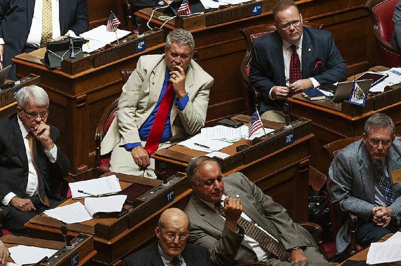 Delegates listen to a speaker during a special session of the state House of Delegates in Charleston, W.Va., on Monday.