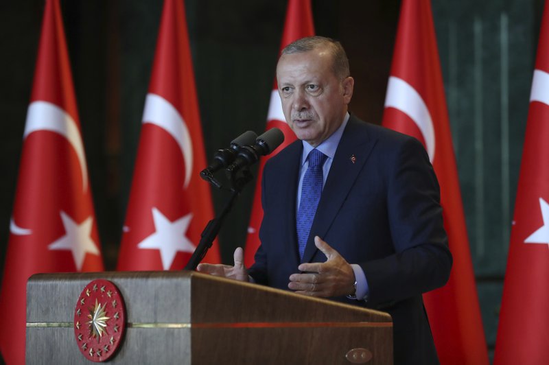 Turkey's President Recep Tayyip Erdogan, gestures as he delivers a speech to Turkish ambassadors at the Presidential Palace in Turkey, Monday, Aug. 13, 2018.Erdogan says his country is under an economic &quot;siege&quot; that has nothing to do with its economic indicators. He insisted that Turkey's economic dynamic remain strong and said the Turkish currency would soon settle &quot;at the most reasonable level.&quot; (Pool Photo via AP)