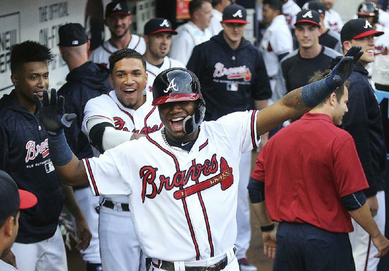 Ronald Acuna Jr. (shown) of the Atlanta Braves became the youngest major league player to homer in five consecutive games, doing it Tuesday night against the Miami Marlins when he hit his third leadoff shot in a row. 