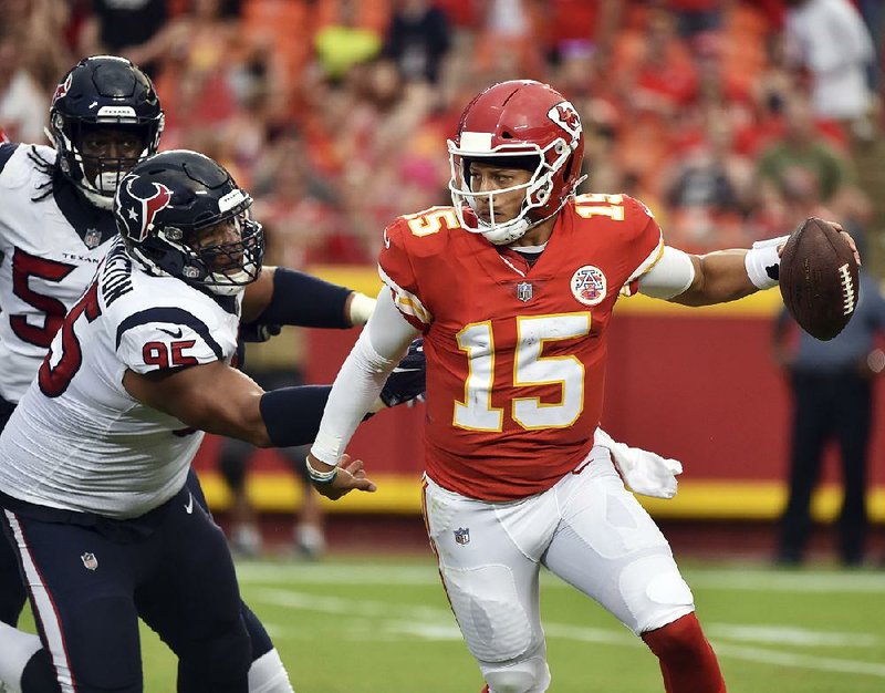 Houston Texans defensive end Christian Covington (95) pursues Kansas City Chiefs quarterback Patrick Mahomes (15) during the first half Thursday in Kansas City, Mo. Mahomes’ success this season probably will be dictated by how well he is protected by the offensive line, which returns nearly intact.  