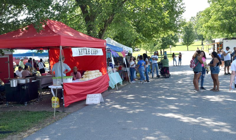 Westside Eagle Observer/MIKE ECKELS Barbecue patrons had a chance to browse through a host of arts and crafts booths on hand at Veterans Park for the 65th Annual Decatur Barbecue Aug. 4 in Decatur.