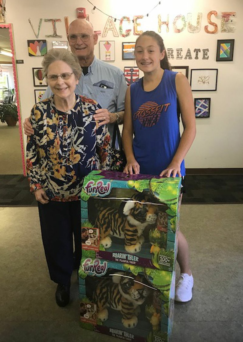 Maysa Willis (right), granddaughter of Ken and Suzanne Willis, presents two &quot;FurReal&quot; Pet Tigers to Village House Adult Day Program last week after raising the funds to purchase them by selling jewelry. One of the Tigers proudly sports one of the necklaces that Maysa sold.