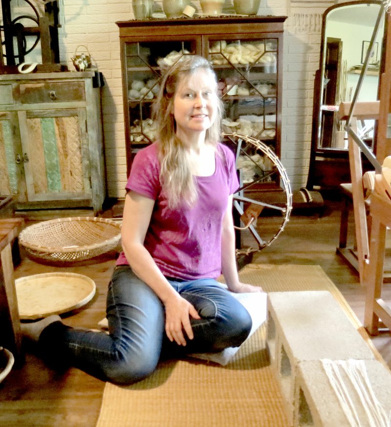 Photo submitted Susan J. Byrd sits amidst her creative elements of artistry to include her shifu weaving and reclaimed art.