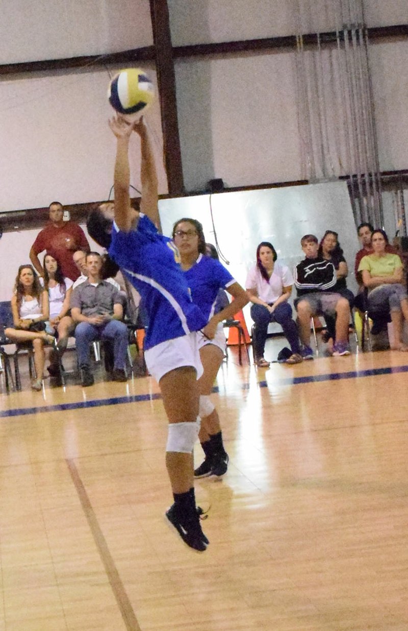 Westside Eagle Observer/MIKE ECKELS Lady Bulldog Kaylee Morales passes the ball off during the Decatur-NWA Classical Academy volleyball scrimmage at Spartan gym in Bentonville Aug. 2. This game was a precursor to the opening of the regular season match with Eureka Springs Aug. 21 at Peterson Gym in Decatur.