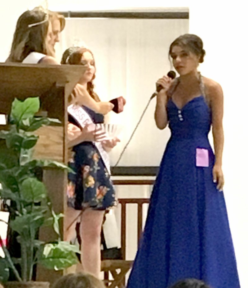 Westside Eagle Observer/SUBMITTED PHOTO Desi Meek answers a question posed by the reigning Miss Benton County Fair queen during the interview portion of the Miss Benton County Fair pageant in the auditorium of the Benton County Fair Grounds Aug. 5.