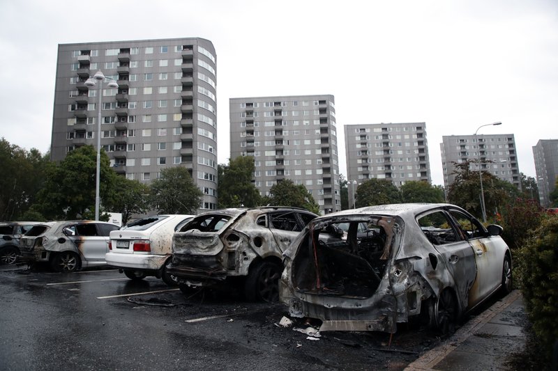 The Associated Press ANGRY RESPONSE: Burned cars parked at Frolunda Square in Gothenburg, Tuesday. Masked youth torched dozens of cars overnight in Sweden and threw rocks at police, prompting an angry response from the prime minister, who on Tuesday spoke of an "extremely organized" night of vandalism.