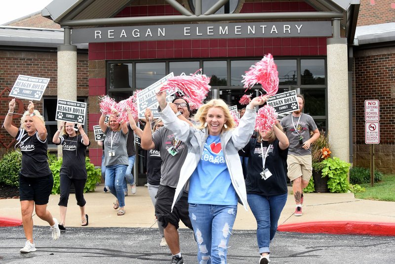 NWA Democrat-Gazette/FLIP PUTTHOFF Reagan Elementary School teachers including Lauren Sullivant (front) make a video Tuesday for the Rogers School District before setting out to greet students and parents in neighborhoods served by the school.