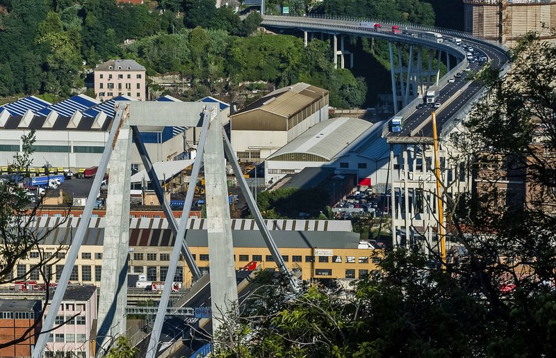 General view of a section of the collapsed Morandi highway bridge in Genoa, northern Italy, Wednesday, Aug. 15, 2018. A bridge on a main highway linking Italy with France collapsed in the Italian port city of Genoa during a sudden, violent storm, sending vehicles plunging 90 meters (nearly 300 feet) into a heap of rubble below. (AP Photo/Nicola Marfisi)

