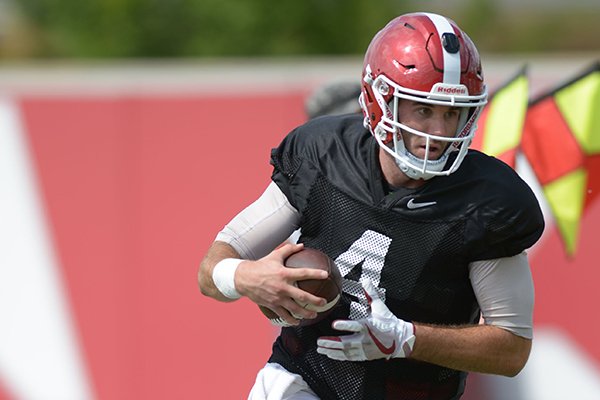 Arkansas quarterback Ty Storey carries the ball Thursday, Aug. 9, 2018, during practice at the university's practice facility in Fayetteville. 