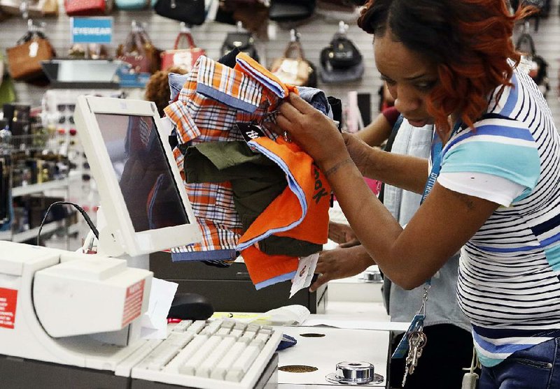 Crystal Bowman, manager of Citi Trends clothing store in Jackson, Miss., rings up clothes for a customer last month. 