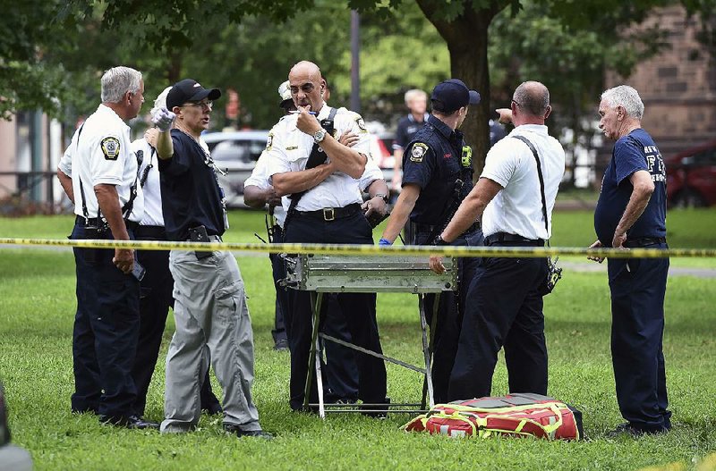 Emergency personnel respond to 46 overdose reports Wednesday in a historic downtown park in New Haven, Conn.  