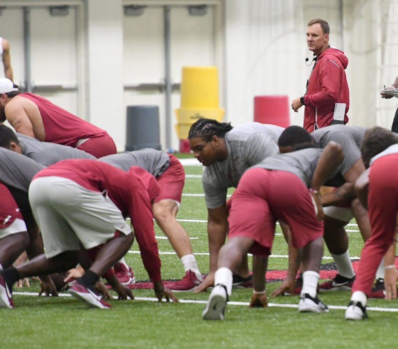 NWA Democrat-Gazette/J.T. Wampler HEAD HOG: Razorback head coach Chad Morris watches his squad run drills with no pads at practice Wednesday. The team has another contact practice session set for today leading into Saturday's scrimmage.