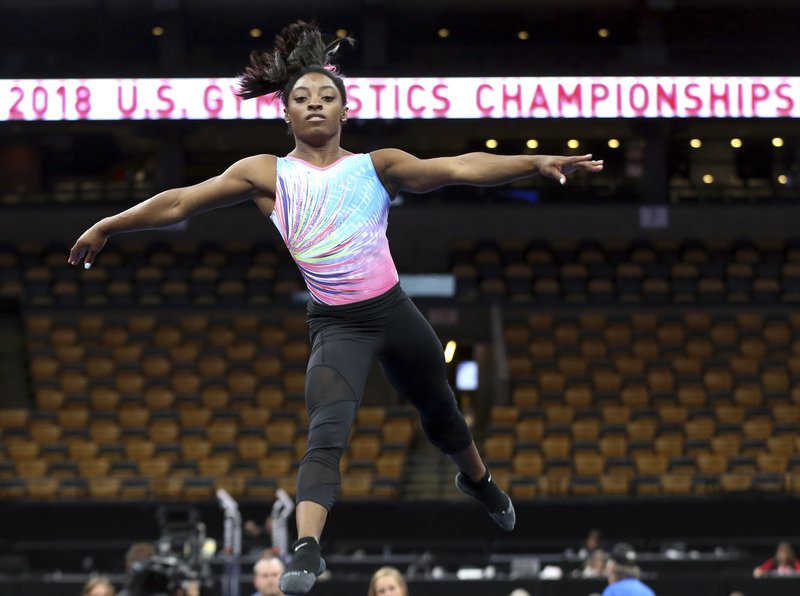 Simone Biles practices on the floor during a training session at the U.S. Gymnastics Championships, Wednesday, Aug. 15, 2018, in Boston. 