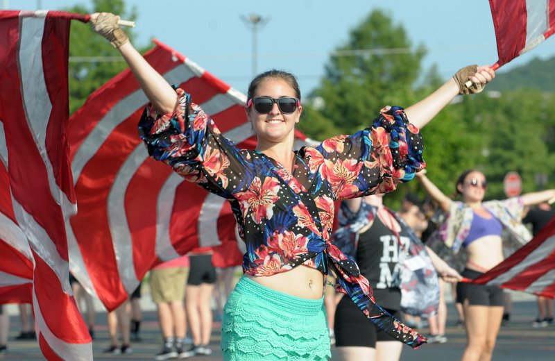 NWA Democrat-Gazette/DAVID GOTTSCHALK Michaela Moder, a senior member of the Razorback Marching Band's Color Guard practices Thursday with swing flags at the University of Arkansas in Fayetteville. The 350-member band is practicing daily for a performance at the Razorbacks' first home football game Sept. 1 at Reynolds Razorback Stadium in Fayetteville.