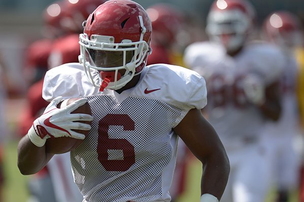 Arkansas running back T.J. Hammonds carries the ball Thursday, Aug. 9, 2018, during practice at the university's practice facility in Fayetteville. Visit nwadg.com/photos to see more photos from practice.
