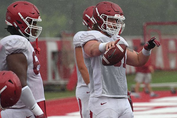 Arkansas offensive lineman Hjalte Froholdt (front) goes through practice Tuesday, Aug. 14, 2018, in Fayetteville. 