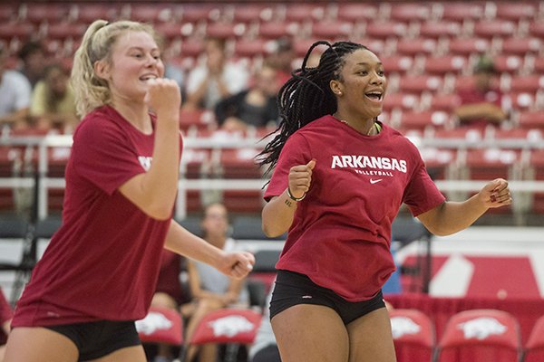 Allyson Dernehl (left) and Elizabeth Pamphile celebrate a point Saturday, Aug. 11, 2018, during the Arkansas volleyball Red-White Game at Barnhill Arena in Fayetteville.
