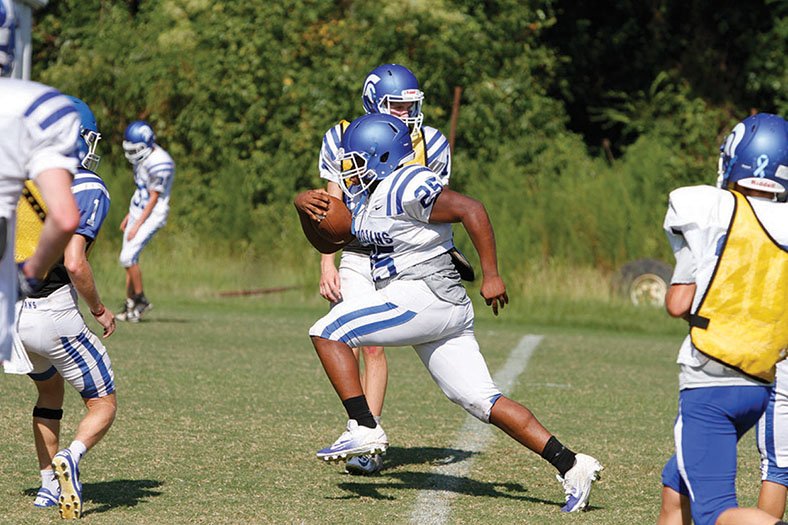 Terrance Armstard/News-Times Parkers Chapel's Kori Morris (25) looks for running room during a team scrimmage. The Trojans will host Beekman Charter (La.) tonight at 7 p.m. in a benefit game. Two other schools will play their benefit games tonight with Strong hosting Lafayette County, and Smackover playing at Magnet Cove. El Dorado will be hosting its annual Purple & White Game tonight at Memorial Stadium.