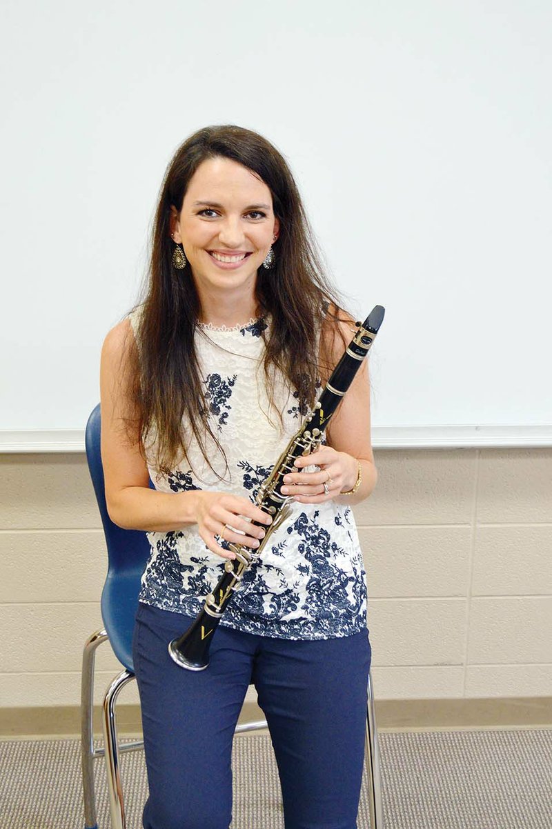 Lauren Lacy holds a clarinet in the band room at Bob and Betty Courtway Middle School in Conway, where she is starting her first year as a band director. Lacy, 26, is the daughter of Robin and Carol-Jean Ratliff of Conway, and her father is the high school band director. Lacy said her motto for teaching is “progress, not perfection.”