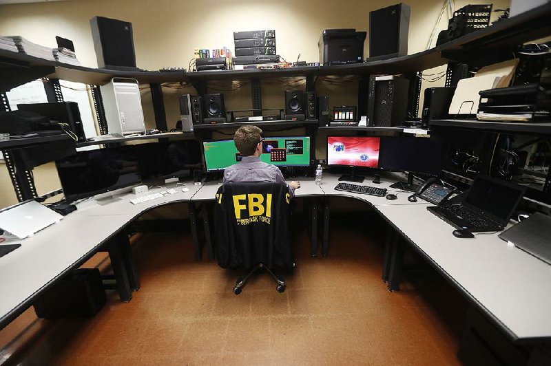 An FBI employee works in a computer forensics lab at the FBI field office in New Orleans last month. 