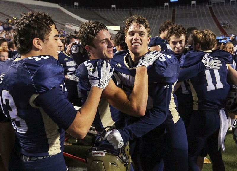 Pulaski Academy’s (from left) Grant Pignio, John David White and Blake Titus celebrate with teammates after their 37-36 victory over Little Rock McClellan in the Class 5A state championship Dec. 2 at War Memorial Stadium. White and Titus are among the key returners this season as the Bruins go for their fifth consecutive state title.