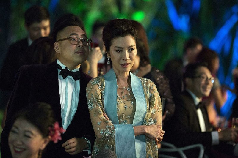 Oliver (Nico Santos) is the bride’s gay BFF and Eleanor Young (Michelle Yeoh) is the disapproving mother of the groom in Crazy Rich Asians. 