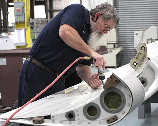 The Sentinel-Record/Beth Reed MAKING REPAIRS: Roy Looper, senior mechanic at Triumph Airborne Structures at 115 Centennial Drive, works on an A300 slat on Thursday. Triumph Airborne Structures will hold its first job fair on Aug. 22 to recruit new mechanically-inclined workers to its team.