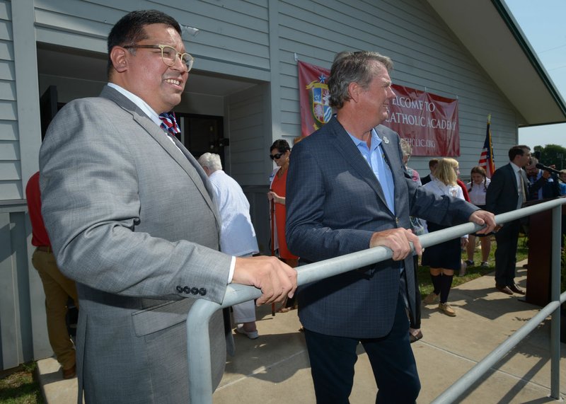 John Rocha (left), head of school for Ozark Catholic Academy, speaks Thursday with Mark Breden, board president, during a ribbon-cutting and open house for the new school in Tontitown. The academy is the first Catholic high school in Northwest Arkansas.