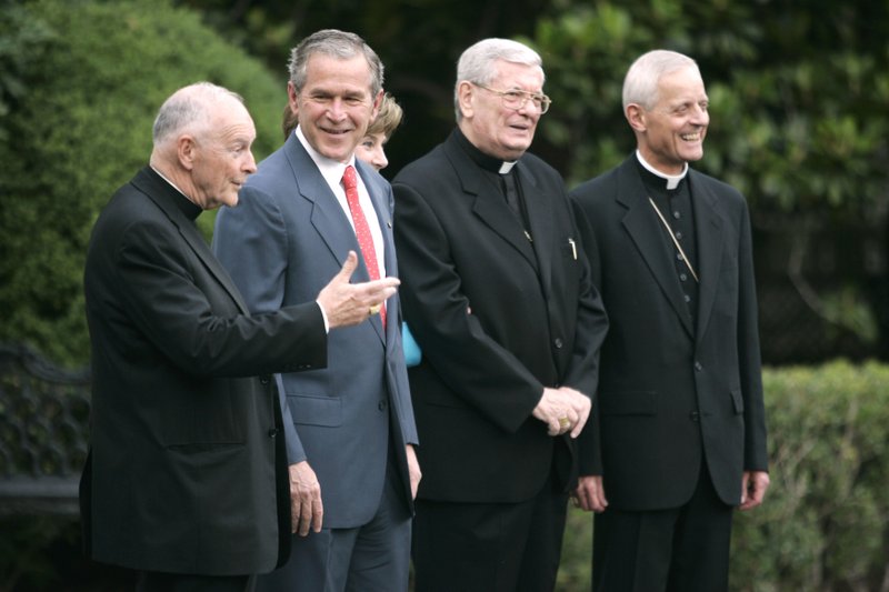 In this Tuesday, July 18, 2006 file photo, President Bush, second from left, smiles at Cardinal Theodore McCarrick, left, during a photo opportunity on the South Lawn of the White House in Washington. From left is McCarrick, Bush, first lady Laura Bush, Papal Nuncio Pietro Sambi, and Archbishop of Washington Donald W. Wuerl. 
