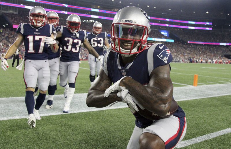 New England Patriots wide receiver Cordarrelle Patterson strikes a pose after scoring a touchdown against the Philadelphia Eagles during the second half of a preseason NFL football game, Thursday, Aug. 16, 2018, in Foxborough, Mass. (AP Photo/Mary Schwalm)