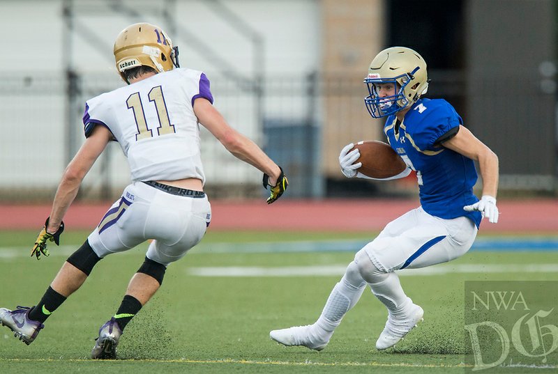 NWA Democrat-Gazette/BEN GOFF Rilee Jones, Harrison wide receiver, evades Wyatt Poe (11), Berryville cornerback, Friday, Aug. 17, 2018, during a scrimmage at F.S. Garrison Stadium in Harrison.