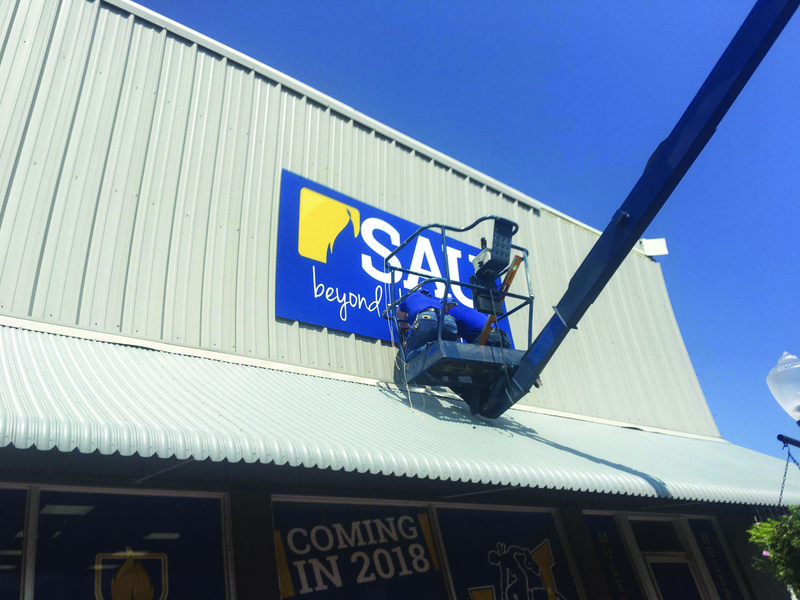 The sign for SAU’s new downtown hub is erected Thursday morning.