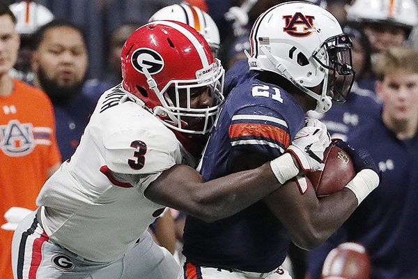 Georgia linebacker Roquan Smith (3) tackles Auburn running back Kerryon Johnson (21) during the second half of the Southeastern Conference championship NCAA college football game, Saturday, Dec. 2, 2017, in Atlanta. (AP Photo/David Goldman)

