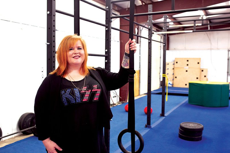 Julia Bullock, founder of Aspie Awesome of Arkansas, stands with some of the equipment in the gym that has been donated by Corps Athletics for her nonprofit’s sensory gym. The gym will provide a place for kids and adults with Asperger’s syndrome or high-functioning autism to play in a safe environment.
