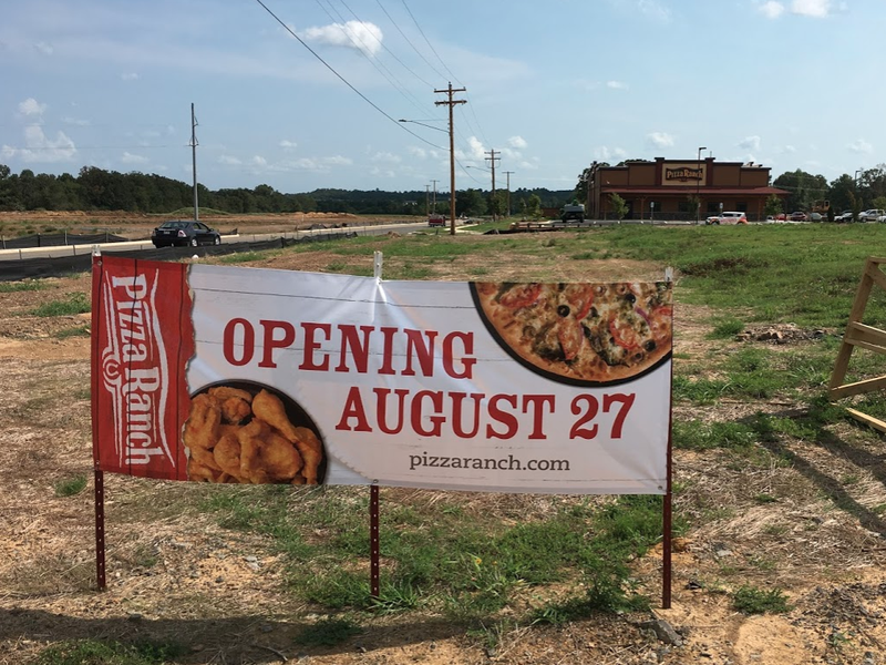 A banner outside the new Pizza Ranch in Conway announces its Aug. 27 opening date.
