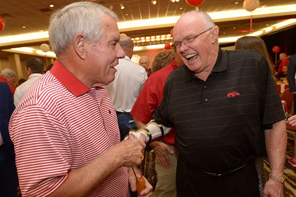 Ken Hatfield (left) shares a laugh Friday, Aug. 17, 2018, with Jesse Branch during the annual Kickoff Luncheon at the Northwest Arkansas Convention Center in Springdale. 