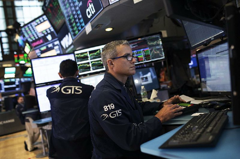 Traders work Friday on the floor of the New York Stock Exchange, where stocks rose in a light session on news that the U.S. and China resumed talks in their trade dispute.