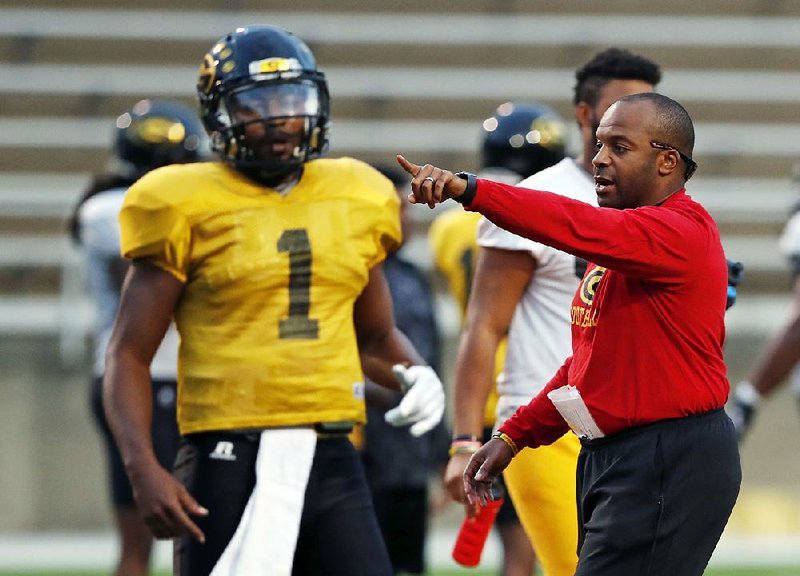 Grambling senior quarterback Devante Kincade (left) listens to Coach Broderick Fobbs during a practice last season in Grambling, La. Fobbs welcomes his new coaching peers in the Southwestern Athletic Conference and any new ideas they bring with them. 