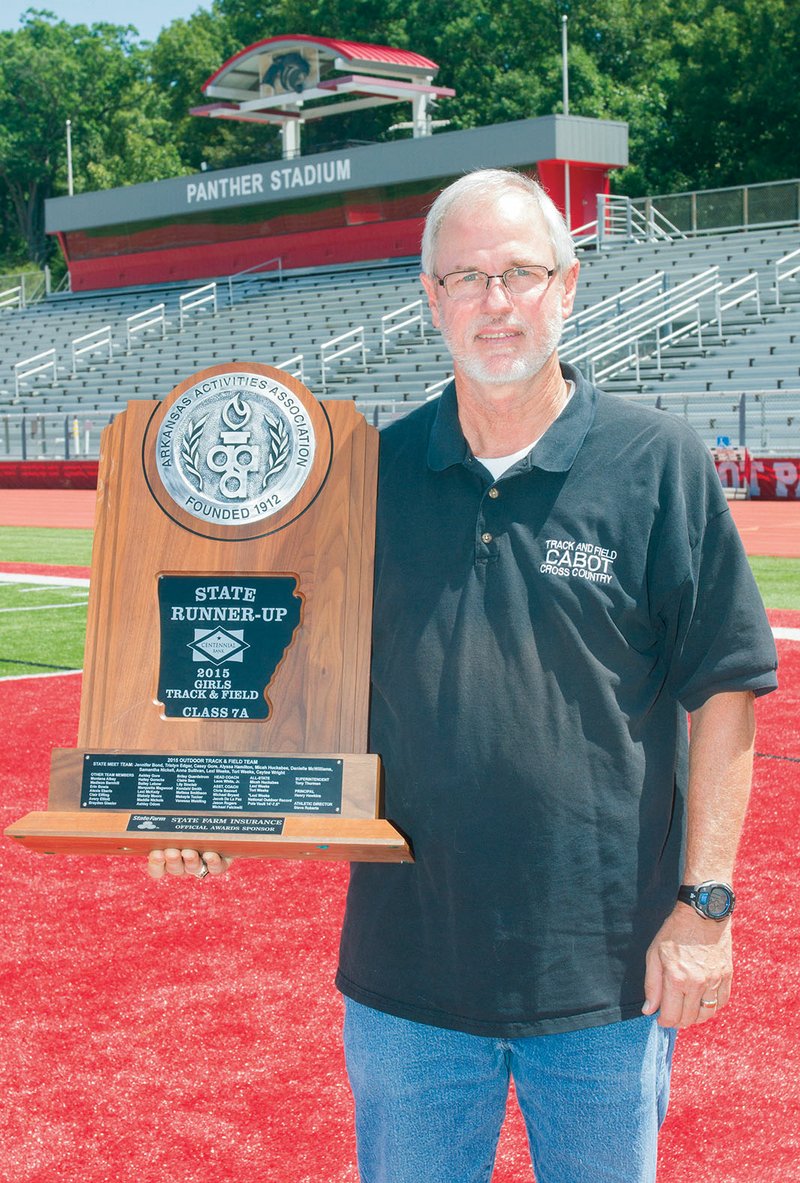 Retired Cabot High School track coach Leon White holds the Class 7A girls state runner-up trophy from 2015, when the Lady Panthers finished second to Bentonville. The team featured former Olympian Lexi Weeks Jacobus. White retired at the end of the 2017-18 school year after 40 years in coaching and teaching, including the past 18 years at Cabot.