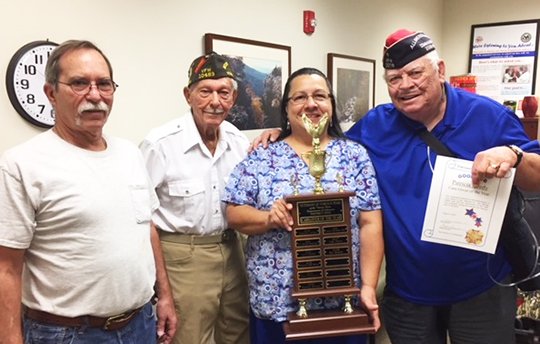 Submitted photo TOP VFW CAREGIVER: Pat Sky-Eagle Reedy was recently presented with the Caregiver of the Year Award for VFW District 9. From left are Robert Lafond, Jack Dobbs, Reedy and Wade Beams.