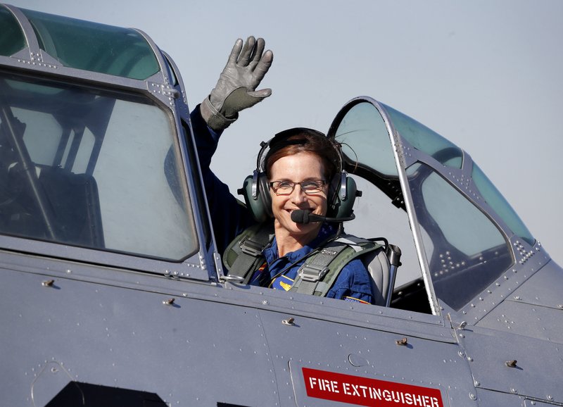 FILE - In this Jan. 12, 2018, file photo, Rep. Martha McSally, R-Ariz., leaves in a T-6 World War II airplane after speaking at a rally in Phoenix. Women with military experience _ many of them combat veterans _ are among the record number of female candidates running for office this year. (AP Photo/Matt York)
