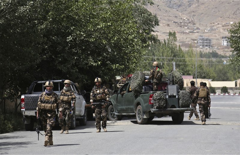 Afghan security forces arrive at the site of an attack by gunmen, in Kabul, Afghanistan, Thursday, Aug. 16, 2018. Gunmen besieged a compound belonging to the Afghan intelligence service in Kabul on Thursday, police said, as the city's Shiite residents held funeral services for the victims of a horrific suicide bombing the previous day that left over 30 dead. (AP Photo/Rahmat Gul)